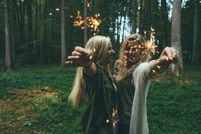 Girls with Sparklers Fireworks in forest