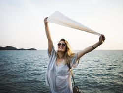 joyful girl in outstretched arms holds a white flag