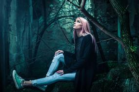 young woman with pink hair in the forest