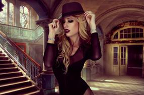 glamorous girl in a hat in an old house
