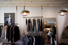 Colorful clothing, lights and mirror in the clothing store