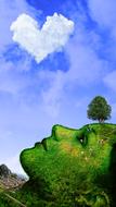 woman in the form of the earth against a blue sky with a white cloud
