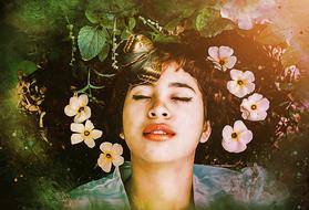 the girl lies in flowers with a butterfly on her head