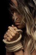 blonde with tied hands close up