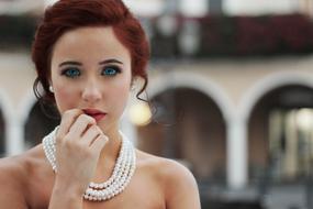 red hair woman with pearl necklace