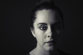 crying woman on black background