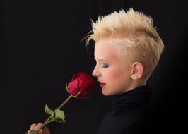 profile portrait of a woman with red rose