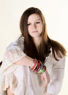 Portrait of the girl, with the colorful bracelets, in light