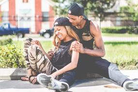 dark-skinned couple resting in the park among the plants