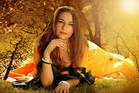 girl in a yellow dress lies in a clearing
