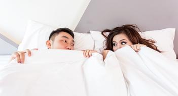Couple looking at each to other in bed