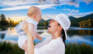 happy mother with a child on the background of picturesque nature