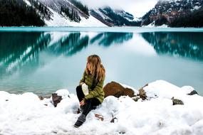 girl on the shore of a picturesque winter lake