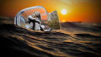 sculpture of a girl in a transparent jar on the sea waves