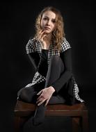 pensive girl sitting on a wooden chair
