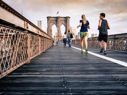 people doing sports on the city bridge in new york