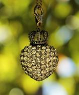 pendant in the shape of an apple with a crown
