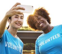 two volunteers take a selfie