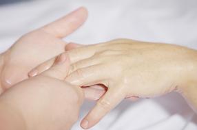 Doing hand massage for the woman
