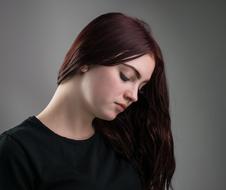 brunette with long hair and lowered head