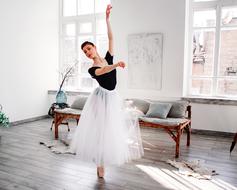 Pointe, young Girl standing on her toes in room