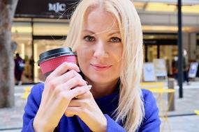 photo of blonde with a glass of coffee