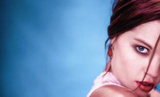 portrait of Girl with brigth Makeup at blurred blue background