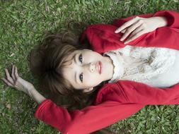 Portrait of asian College girl laying on her back on lawn