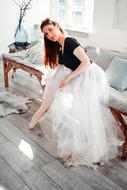 girl in a white skirt near the window