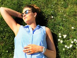 Young Woman rests on Meadow