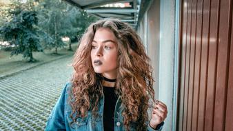 curly woman with dark lipstick