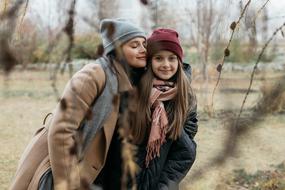photo of happy two sisters in autumn park