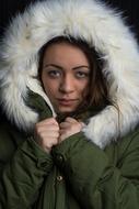 girl in a green jacket with a fur collar