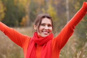 Portrait of happy Girl in red clothes outdoor at fall