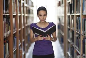 Woman is reading books in the library