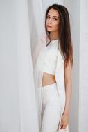 brunette in a white pantsuit