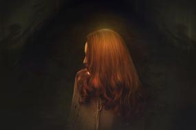 photo of red-haired girl in the dark