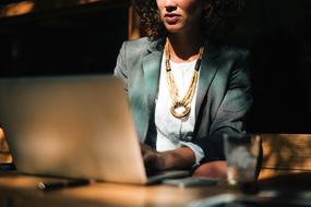 photo of a business woman working on a laptop