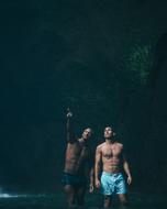 Men in shorts, looking somewhere, on the beautiful landscape