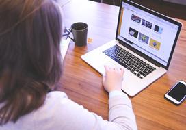 young Woman works with laptop, top view