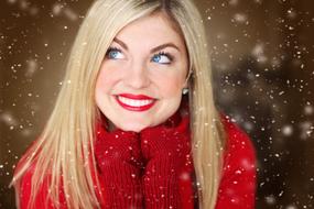 photo of a blonde in a red sweater and red mittens