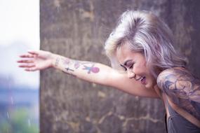 photo of happy blonde with tattoos