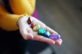 Hand Holding Chakra stone