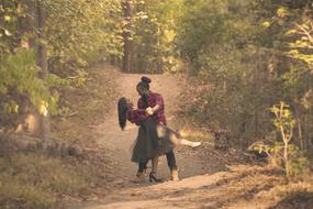 happy couple on the forest path