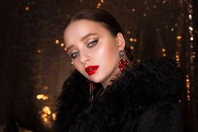 portrait of a girl with red lips on a bokeh background