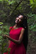 african girl in red dress in the forest