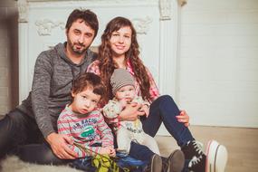 family photo on a background of a white fireplace