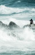 lonely woman on the sea rock