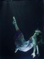 photo of a girl in a dress under water