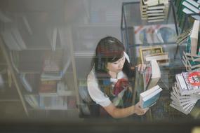 asian Girl with books in library